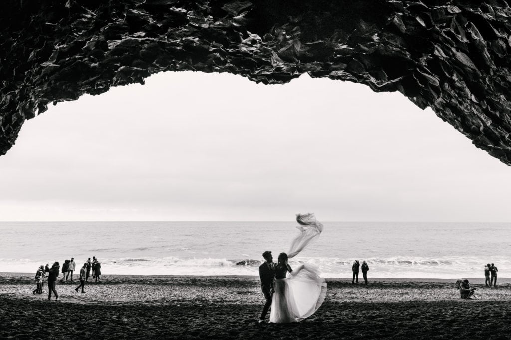 Bride and Groom in cave on black sand beach Reynisfjara