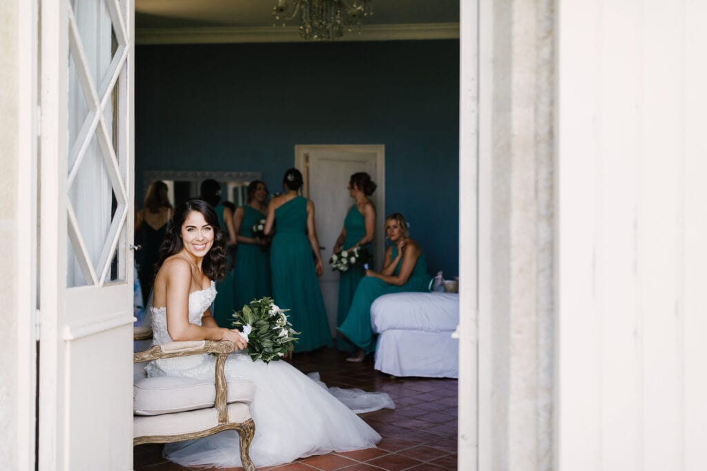 Bride in Pronovias dress at Chateau Soulac in front of window